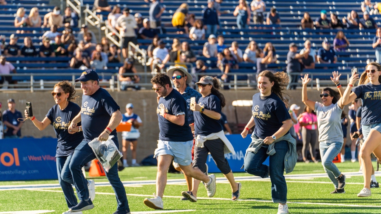 Football team running onto field 2025